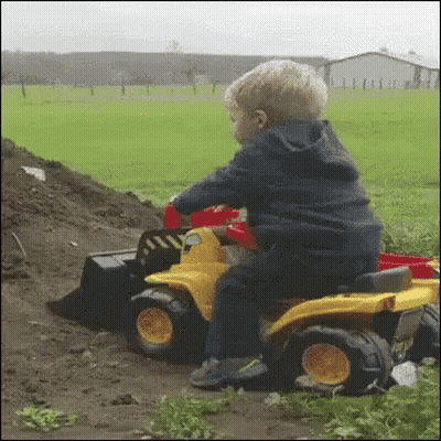 Little Boy Riding Toy Truck GIF