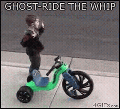 Little Boy Riding Tricycle On Sidewalk GIF