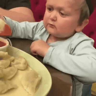 Little Boy Sitting At Table With Plate Of Food GIF