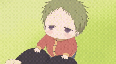Little Boy Sitting On Lap Looking At Camera GIF