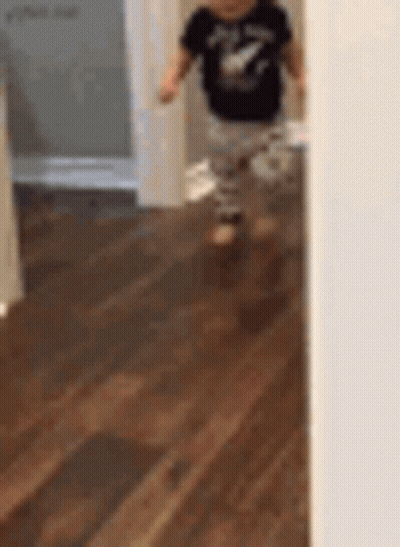 Little Boy Walking In Wooden Hallway GIF