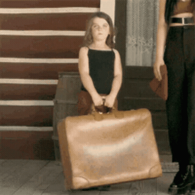 Little Girl Carrying Large Suitcase GIF