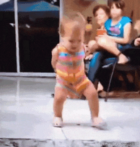 Little Girl Dancing In Front Of Group Sitting On Chairs GIF