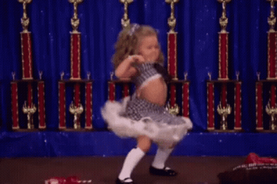 Little Girl Dancing On Stage With Trophies GIF