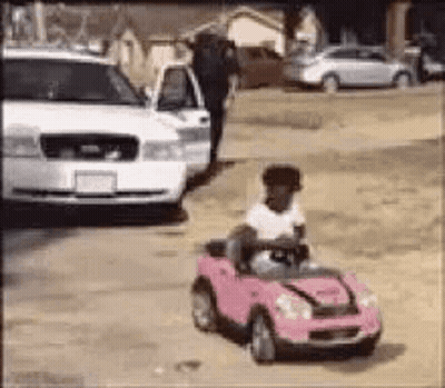 Little Girl Driving Pink Toy Car GIF