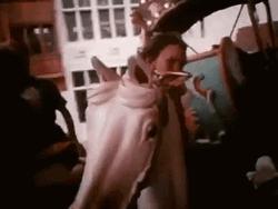 Little Girl Enjoys Merry Go Round GIF
