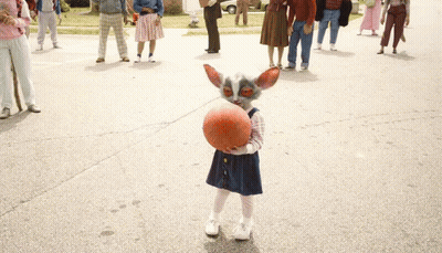 Little Girl Holding Basketball In Front Of Crowd GIF