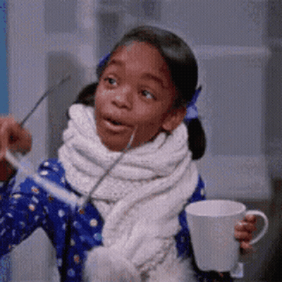 Little Girl Holding Coffee Cup And Spoon GIF