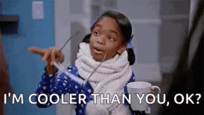 Little Girl Holding Coffee Cup With Spoon In Mouth GIF