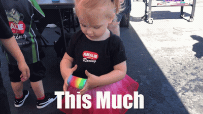 Little Girl In Amalie Racing Shirt Holding Rainbow Object GIF