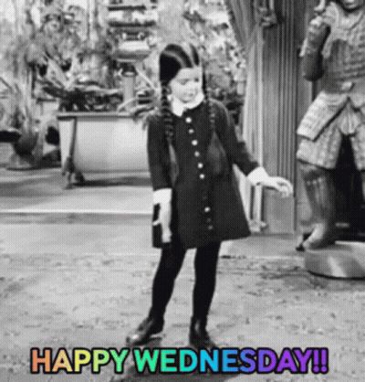 Little Girl in Black Dress Dancing in Front of Statue Happy Wednesday