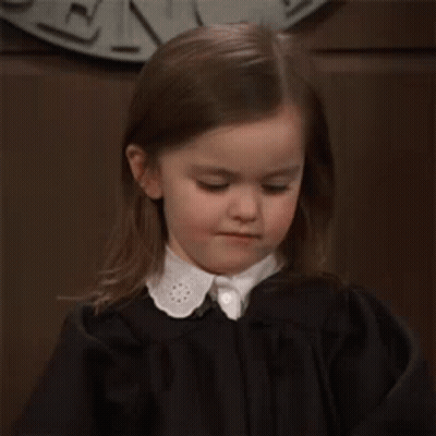 Little Girl In Black Dress Making Angry Face GIF