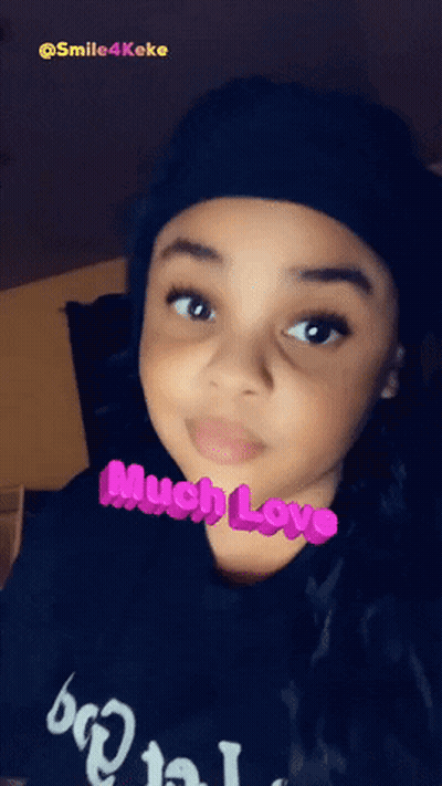 Little Girl In Black Hat And Shirt Saying Much Love GIF