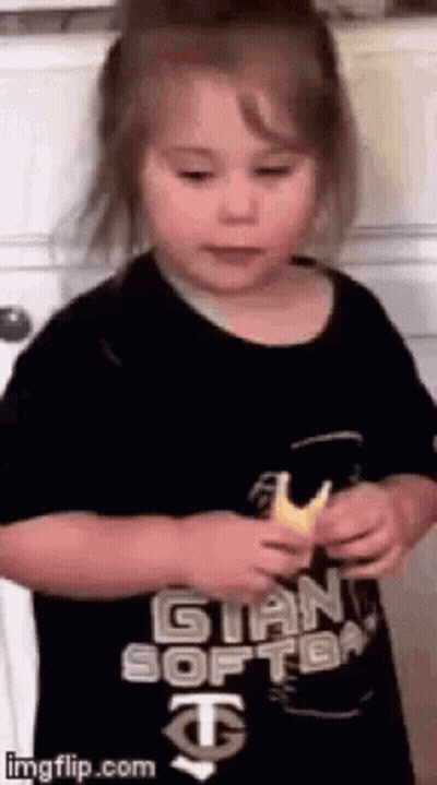 Little Girl In Black Shirt Holding Bread GIF