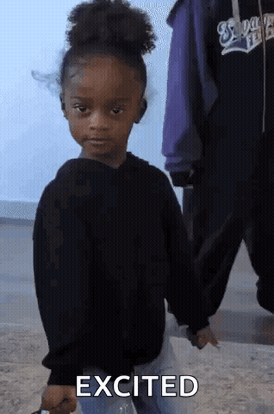 Little Girl in Black Sweater Holding Water Making Funny Face