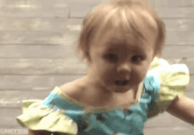 Little Girl In Blue And Yellow Dress Making A Face GIF