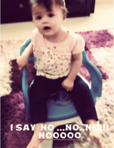 Little Girl in Blue Chair Saying I Say No No No No No