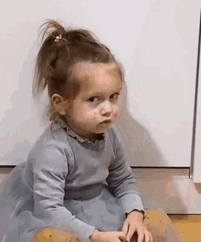 Little Girl In Blue Dress Making Face GIF