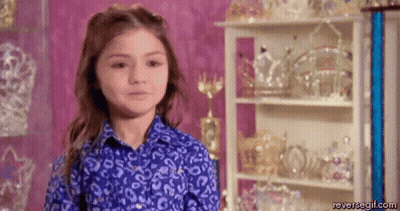 Little Girl In Blue Shirt At Tiara Display GIF