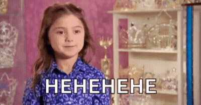 Little Girl In Blue Shirt Laughing In Pink Room GIF