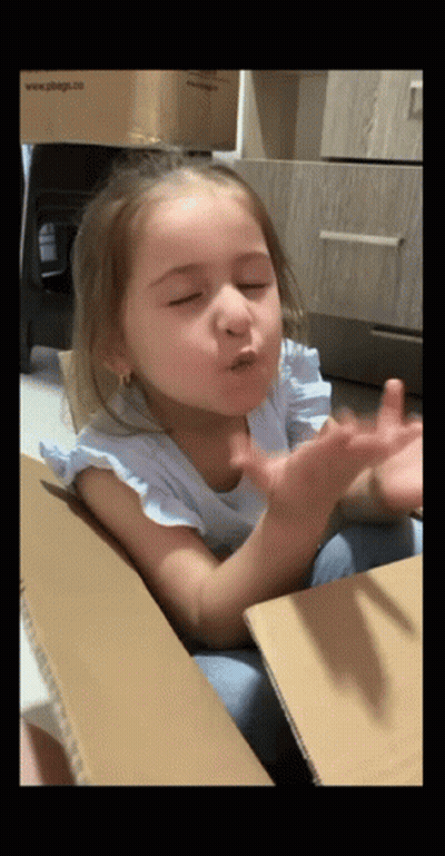 Little Girl In Cardboard Box Blowing A Kiss GIF