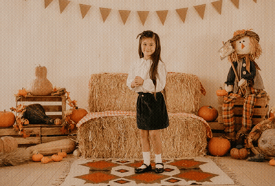 Little Girl In Front Of Hay Bale GIF