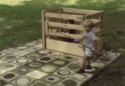 Little Girl In Front Of Wooden Fence GIF