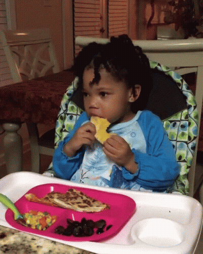 Little Girl In High Chair Eating GIF