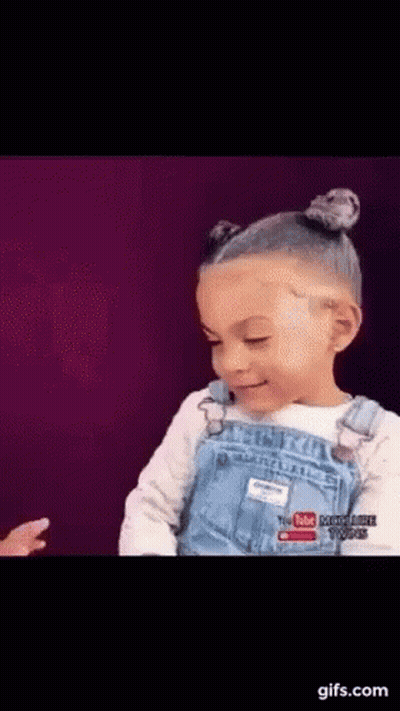 Little Girl in Overalls With YouTube Logo Shirt