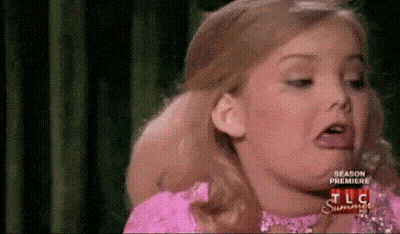 Little Girl In Pink Dress Making A Face GIF