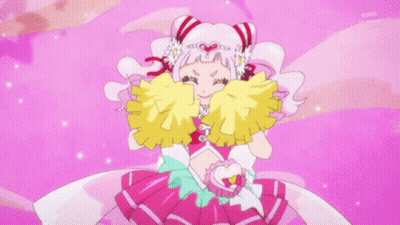 Little Girl In Pink Dress Surrounded By Cheerleaders With Pom Poms GIF
