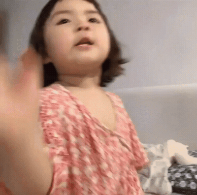 Little Girl in Pink Dress Waving