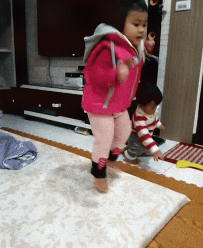 Little Girl In Pink Jacket Jumping GIF