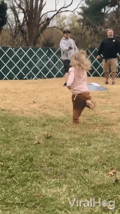 Little Girl In Pink Shirt Running In Grass GIF