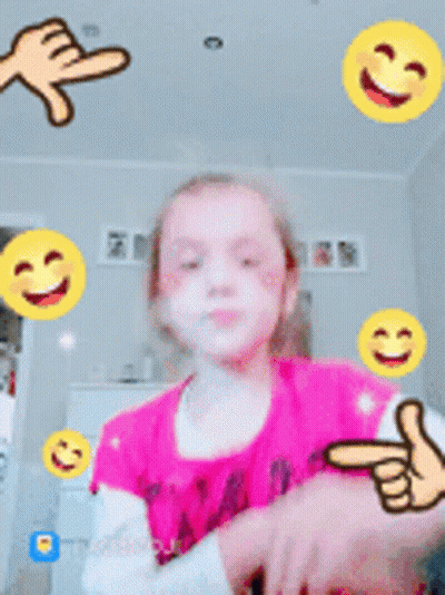 Little Girl In Pink Shirt Surrounded By Yellow Smiley Faces GIF