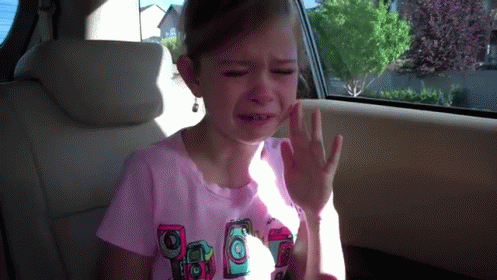 Little Girl In Pink Shirt With Cameras Crying In Car GIF