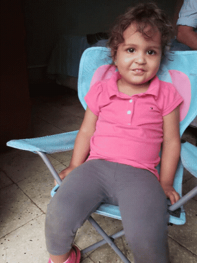 Little Girl In Pink Tommy Hilfiger Polo In Blue Chair GIF