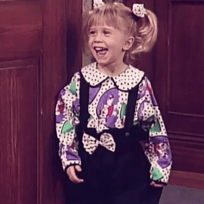 Little Girl In Polka Dot Shirt And Suspenders Smiling GIF