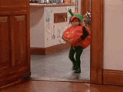 Little Girl In Pumpkin Costume Running Out Of Door GIF