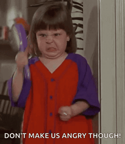 Little Girl In Red And Purple Dress Holding Toy Making Face GIF