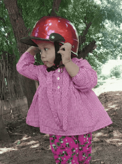 Little Girl In Red Helmet And Plaid Shirt GIF