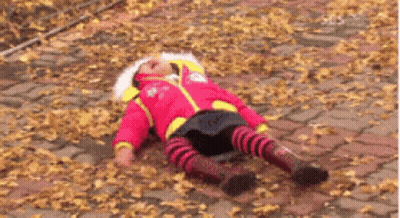 Little Girl In Red Jacket Laying On Ground GIF