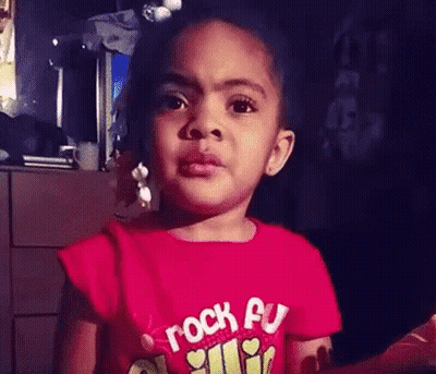 Little Girl In Red Rock On Shirt Making Funny Face GIF