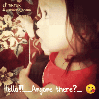 Little Girl In Red Shirt Saying Hello Anyone There GIF