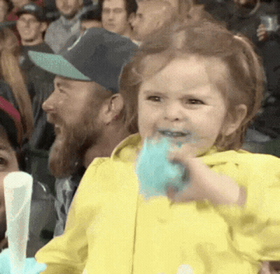 Little Girl In Yellow Jacket Eating Cotton Candy GIF