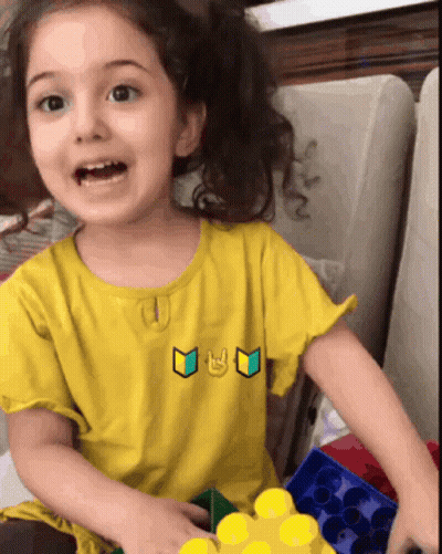 Little Girl In Yellow Shirt With Smiley Face GIF