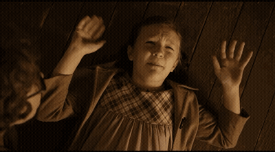 Little Girl Laying On Floor With Hands In Air GIF