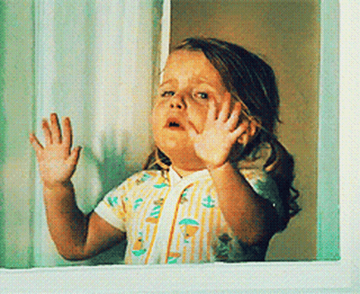 Little Girl Looking Out Window With Hands On Glass GIF