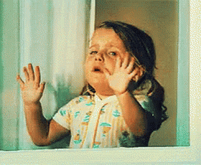 Little Girl Looking Out Window With Hands On Glass GIF