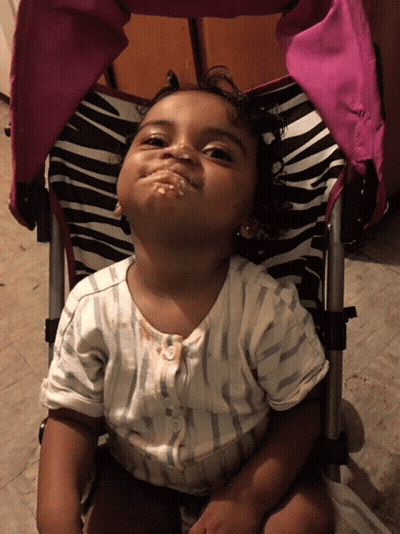 Little Girl Making Face In Zebra Stroller GIF